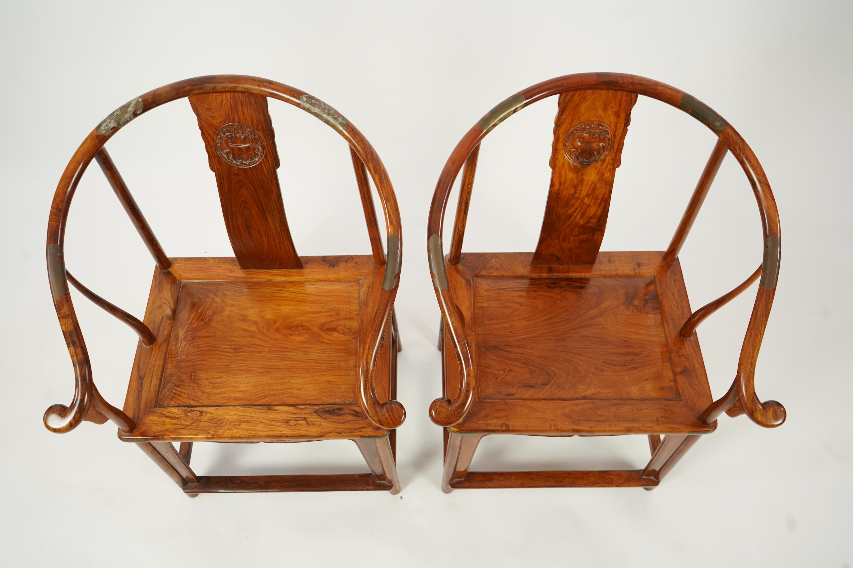 A pair of Chinese huanghuali and brass mounted horseshoe-back armchairs, quanyi, 19th century